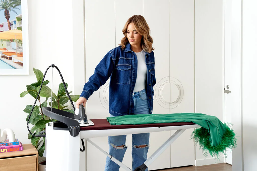 A lady ironing clothing using Miele FashionMaster