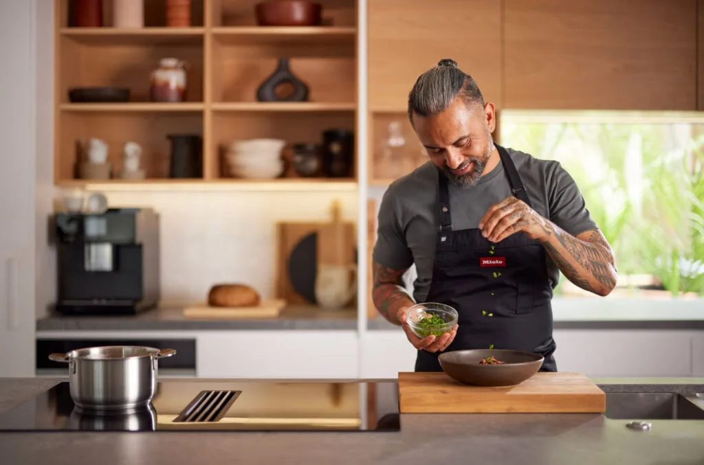 Chef Michael Meredith garnishing his eggs and oats dish