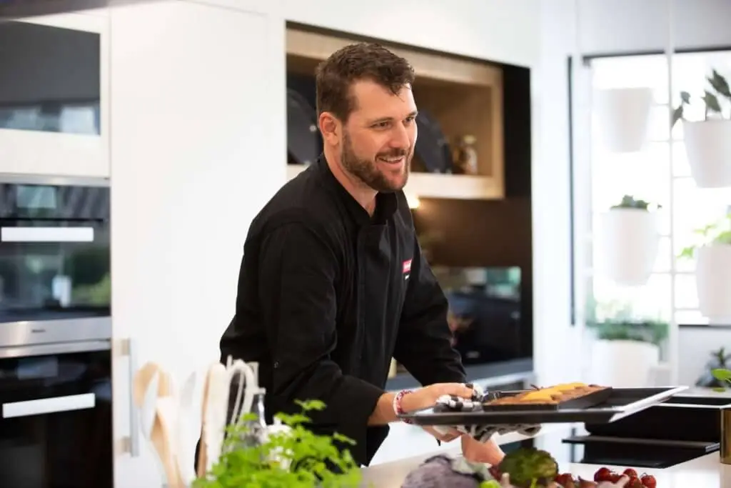 A chef demonstrating Miele appliances at a Miele Experience Centre