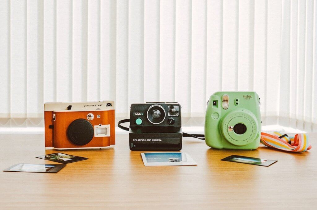 row of multiple polaroid cameras