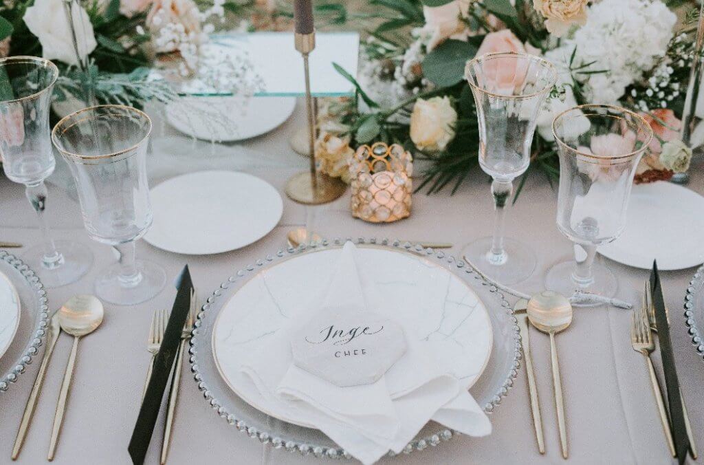 beautifully set table with gold cutlery